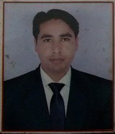 Portrait of Dr. Kapoor wearing traditional attire with academic books in background